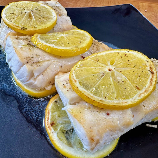 Fish With Lemon on a black plate